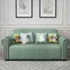 Bambillo Roma Sofa Bed with rolled arms in sage fabric colour, direct front facing showing sofa configuration and with decorative pillows